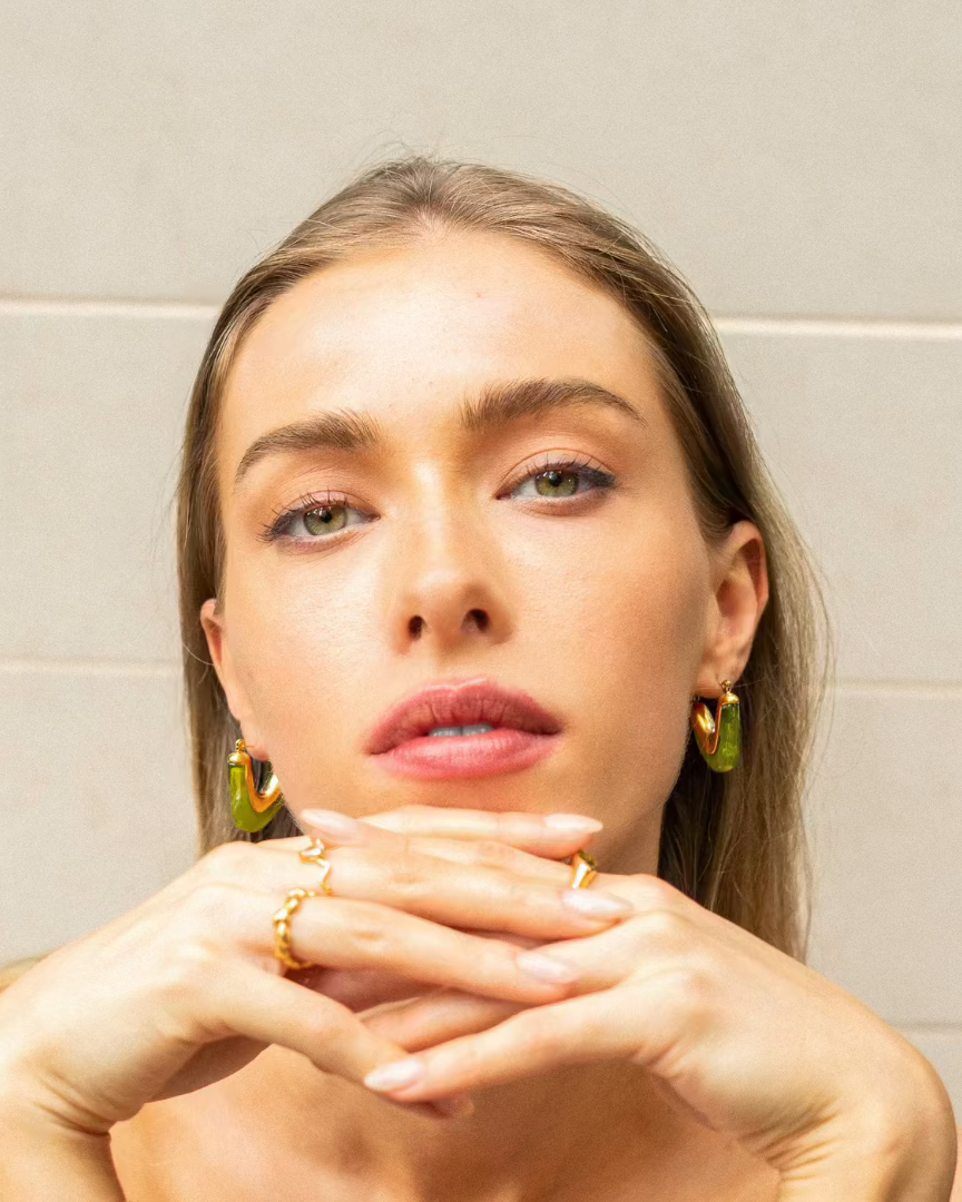 Model wearing statement hoop earrings from the MILA Hoops Collection