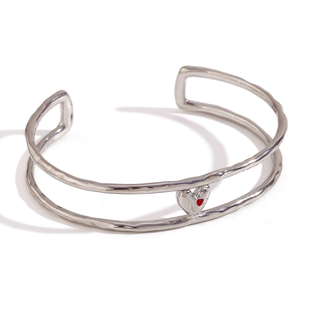 Close-up of silver heart cuff bracelet by Mila Online Shop
