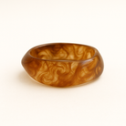 Close up of red wine coloured MA-FRIENDS RESIN BANGLE