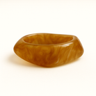 Close up of marble light orange coloured MA-FRIENDS RESIN BANGLE