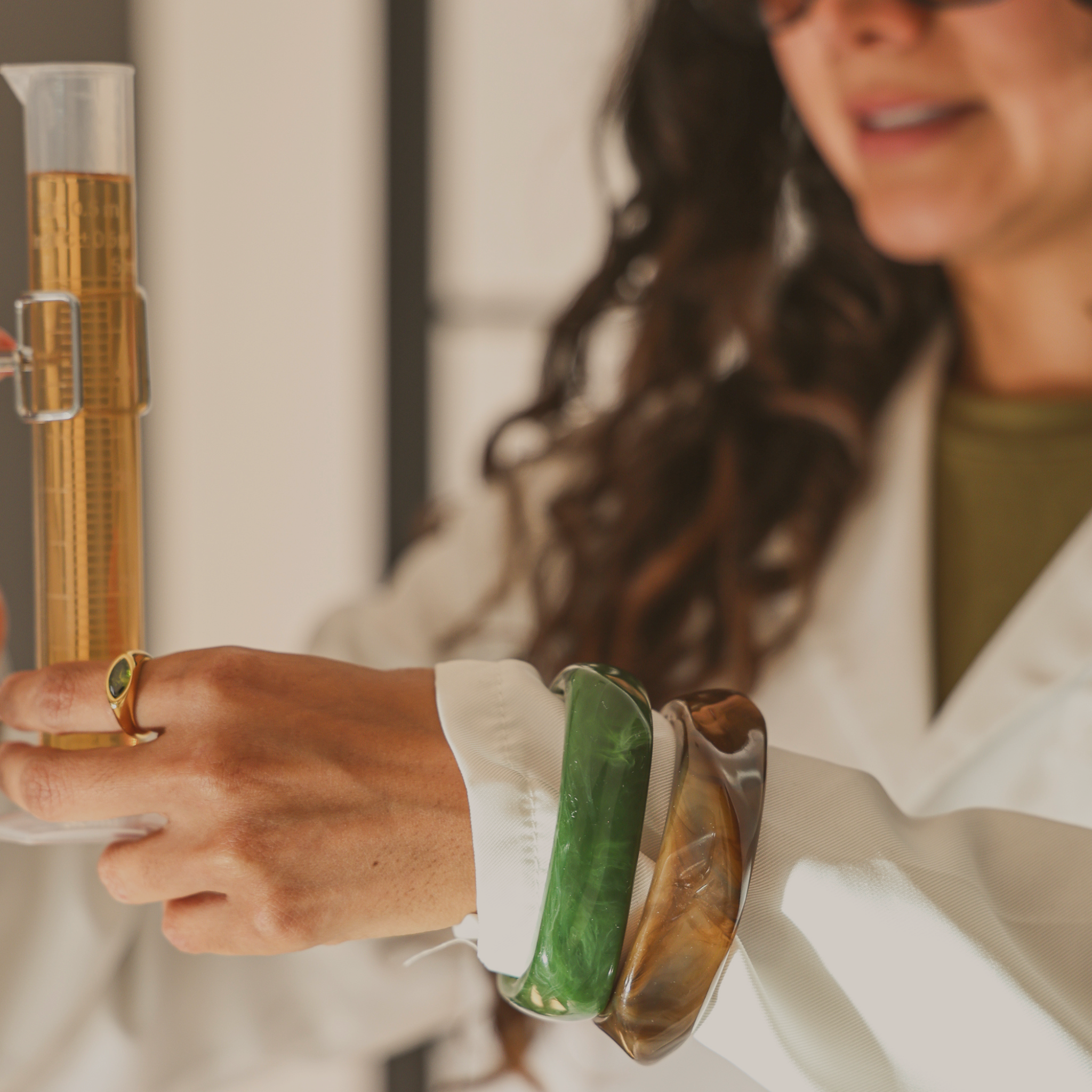 Woman styling chunky resin bangles stack with casual outfit