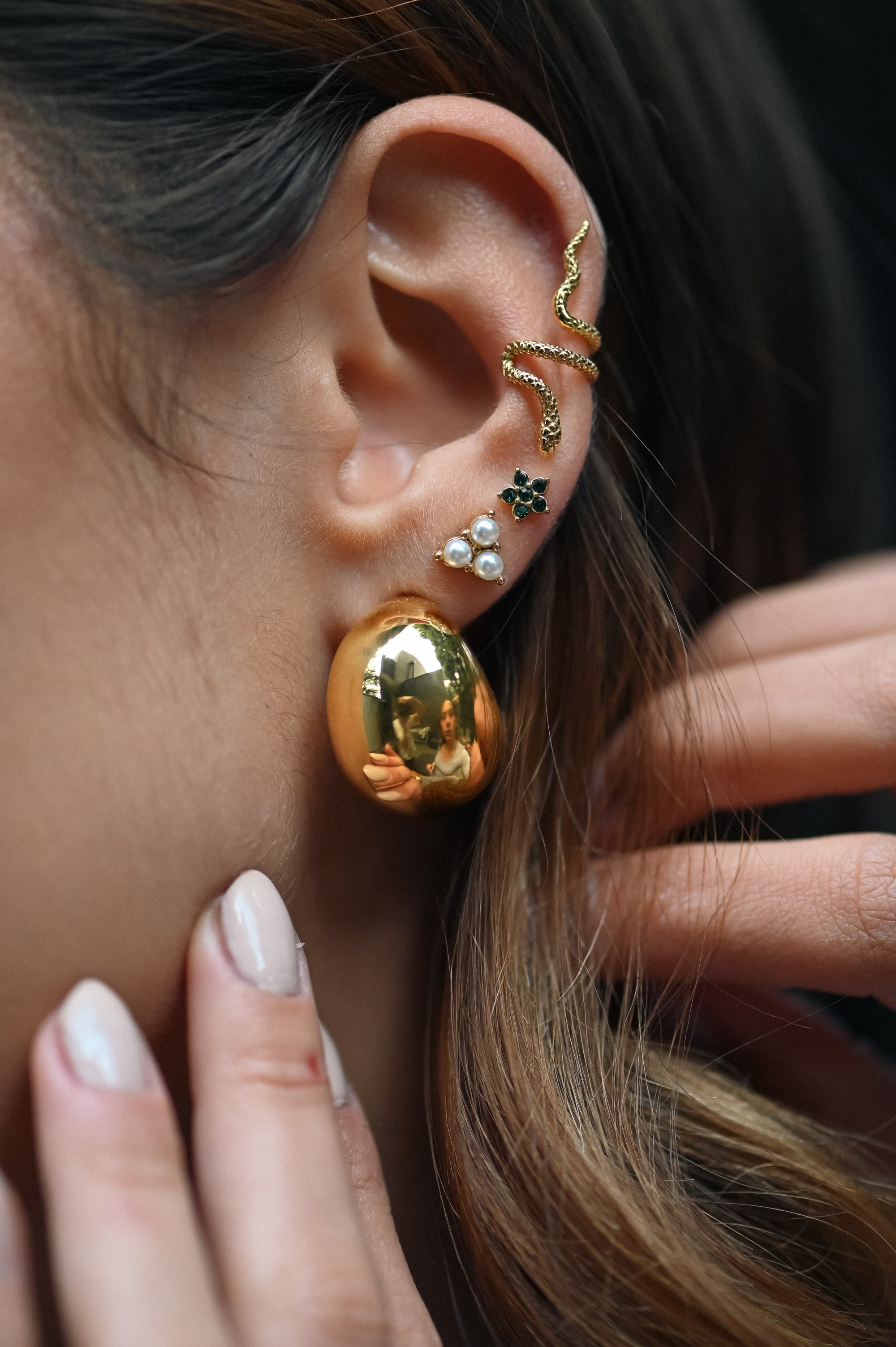 Model wearing Mila’s Flori Green Mini Studs in gold, styled with an ear cuff and two stacked stud earrings — a vibrant, minimalist jewellery look.