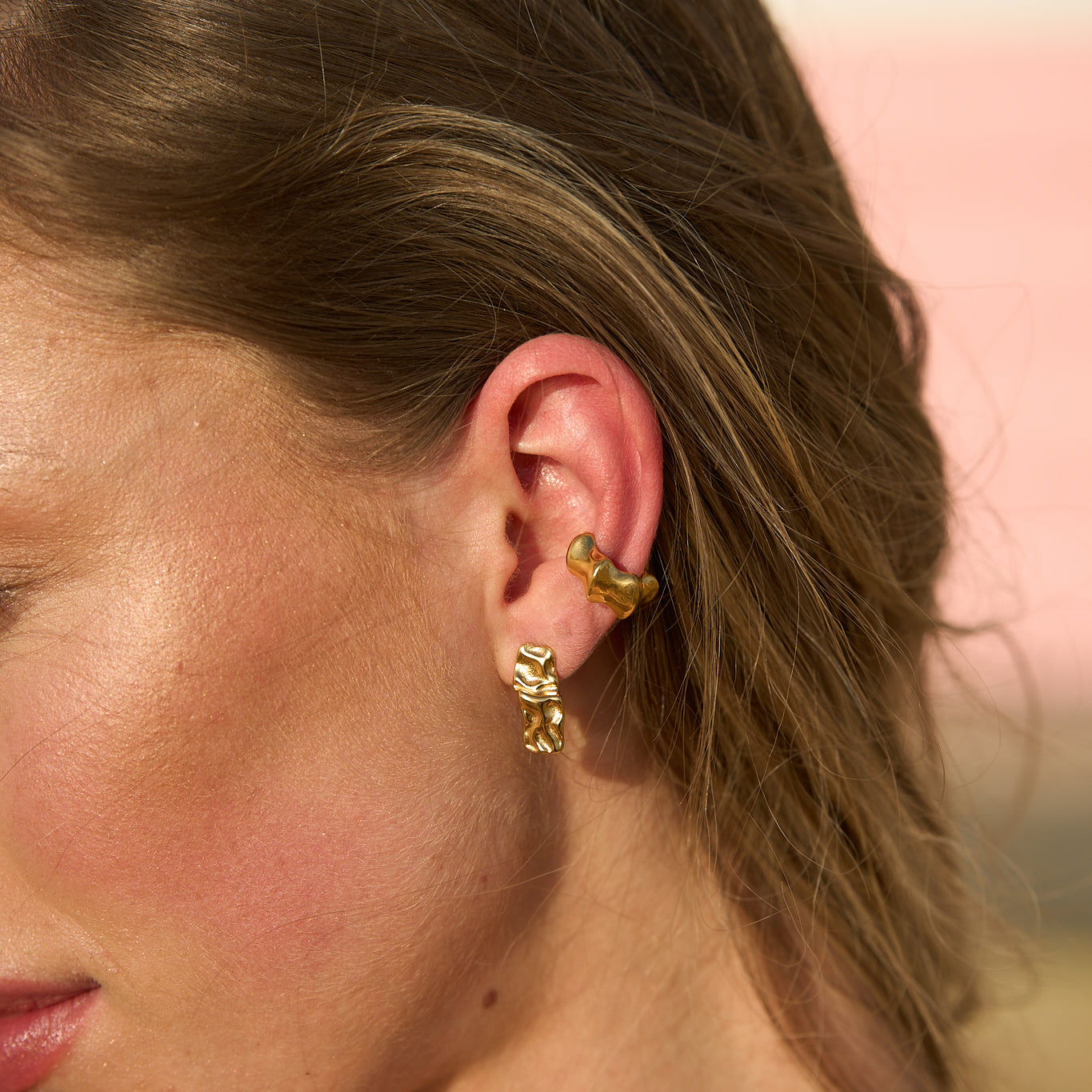 Model wearing gold Mini Maria Stud Earrings paired with ear cuffs – elegant little stud earrings designed for effortless style by Mila Online Shop.