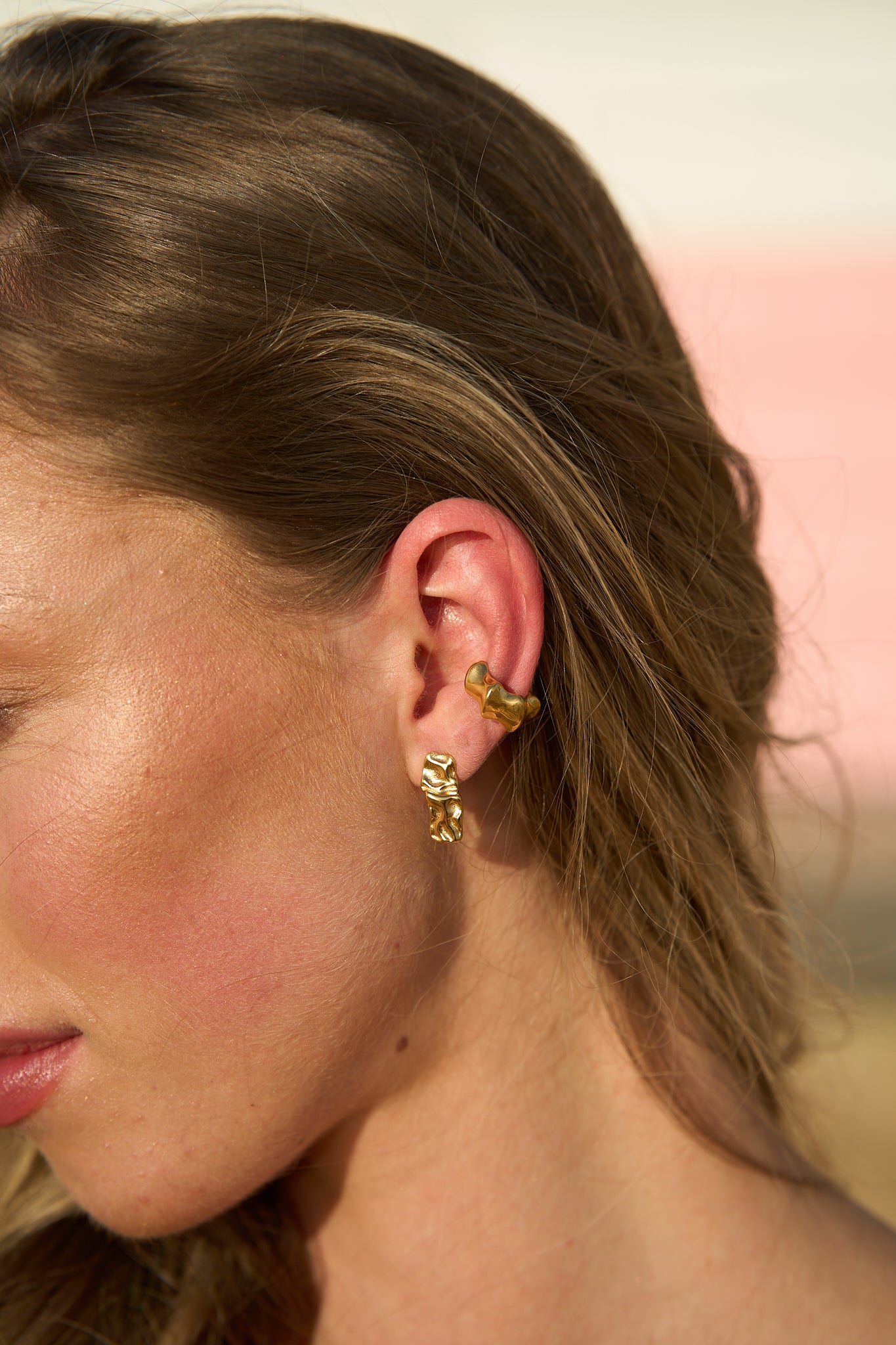 Model wearing gold Mini Maria Stud Earrings paired with ear cuffs – elegant little stud earrings designed for effortless style by Mila Online Shop.