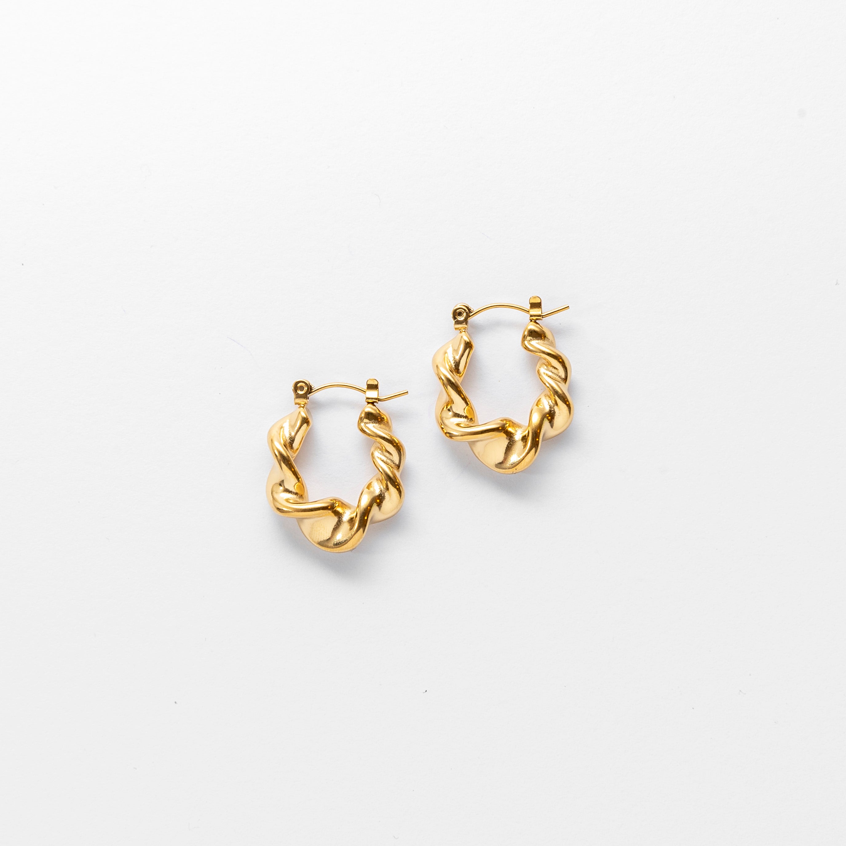 Close up of gold Twist Hoop Earrings by Mila Online Shop. Elegant lightweight hoop earrings. Sculptural jewellery design. Hoop earrings Australia.