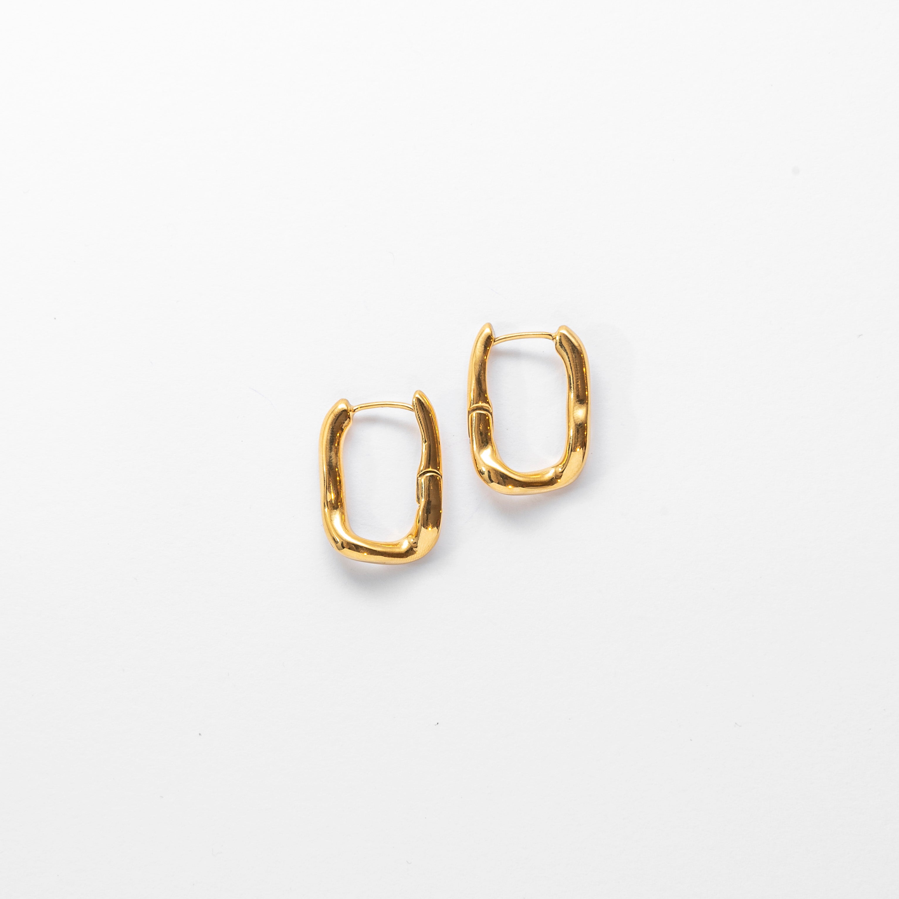 Close up of Wavy Square Hoop Earrings in gold by Mila Online Shop. Sculptural and lightweight hoop earrings designed for everyday style.