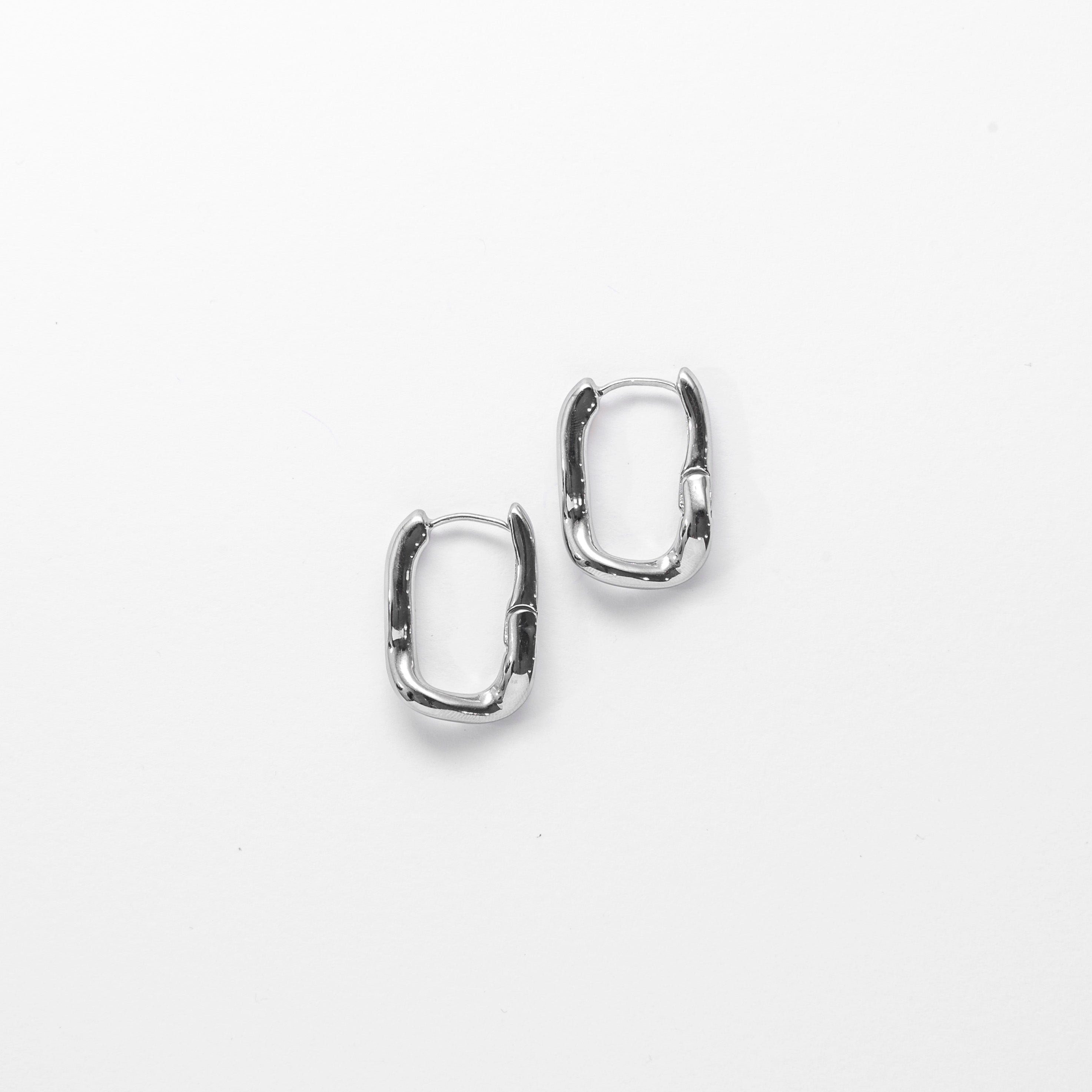 Close up of Wavy Square Hoop Earrings in silver by Mila Online Shop. Sculptural and lightweight hoop earrings designed for everyday style.