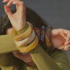 Model wearing stacked resin bangles in bold colours – Mila Online Shop