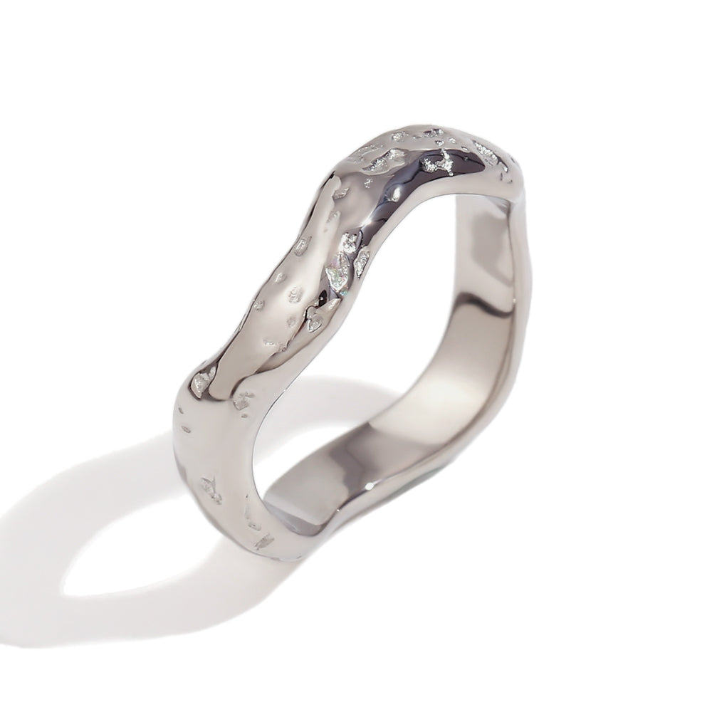 Close up of Mila Online Shop Cristy Ring in silver with sculptural wave design, elegant chunky ring layered with gemstone and gold stackable rings.