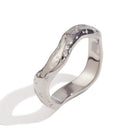 Close up of Mila Online Shop Cristy Ring in silver with sculptural wave design, elegant chunky ring layered with gemstone and gold stackable rings.