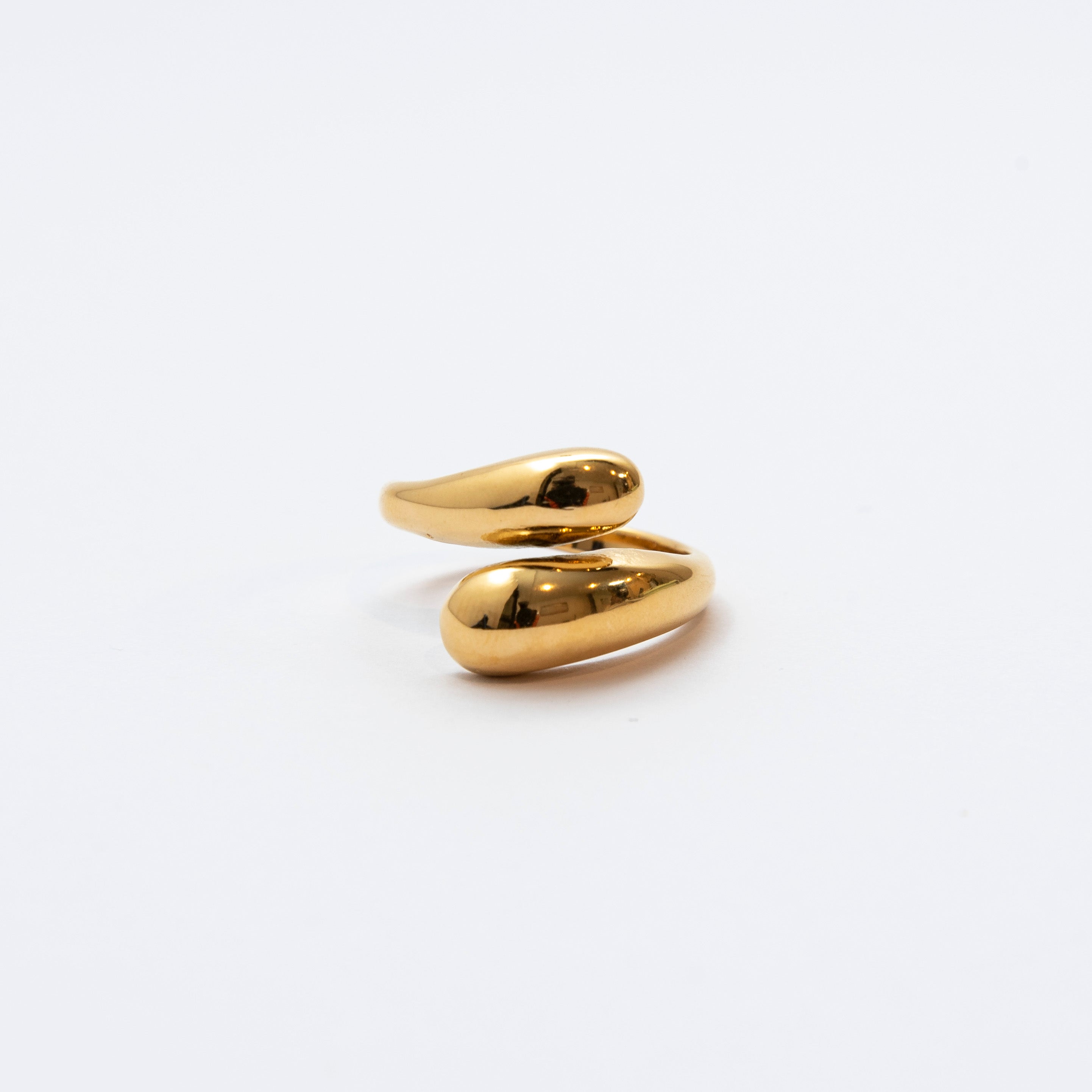 Close up of Mila Online Shop Crossy Ring in gold with two teardrop bands crossing, bold chunky crossover design styled as a modern statement ring.