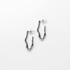 Close up of silver stud earrings — Wave Stud Earrings by Mila Online Shop. Sculptural and minimalist statement studs with a lightweight, waterproof design.